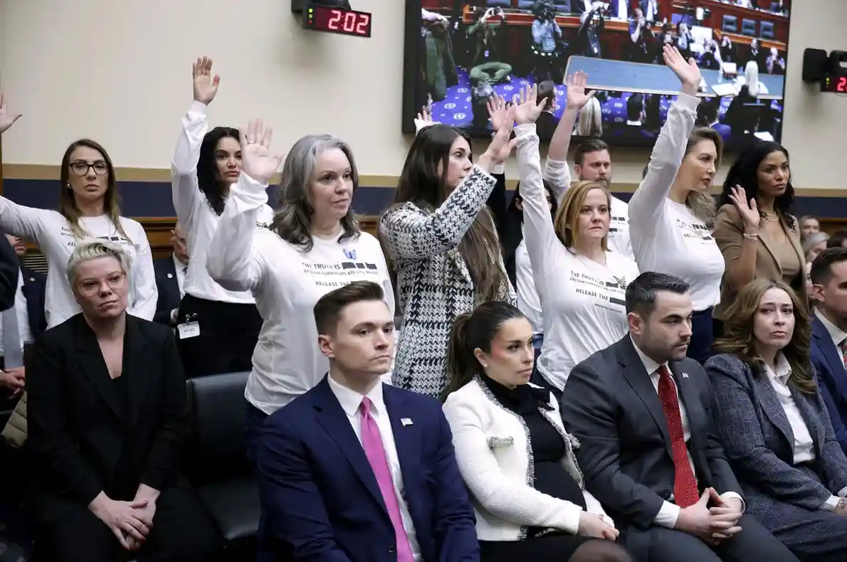 People who survived Jeffrey Epstein raising their hands during a congressional hearing