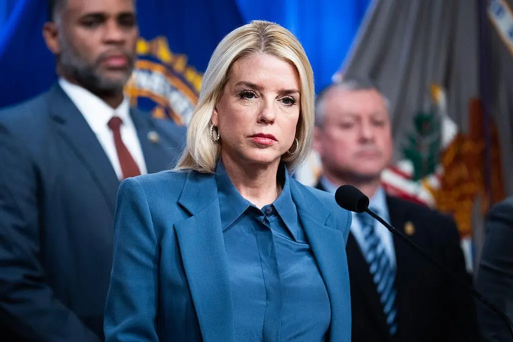 People holding signs against the federal government's access to voter data