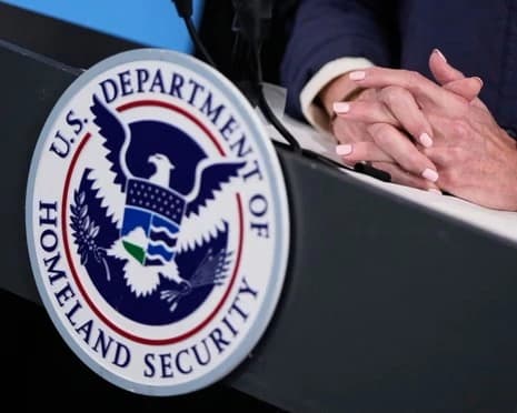 People in the Haitian community holding signs that say they support TPS protections