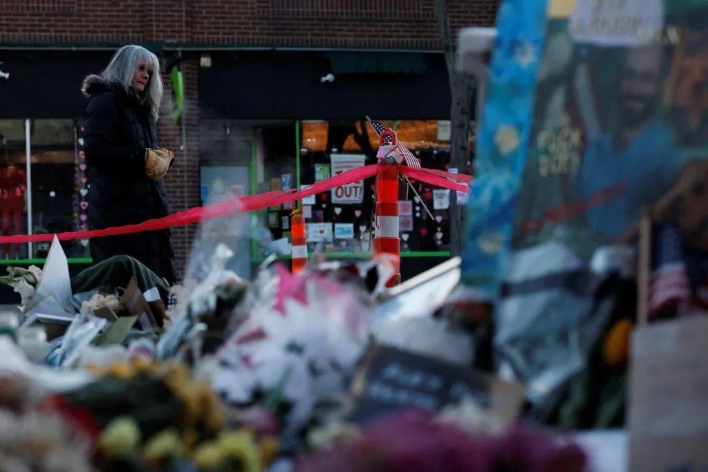 Protesters holding signs against ICE and federal immigration enforcement in Minneapolis